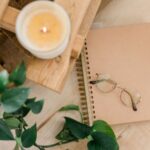 Image of a notebook, candle and houseplant