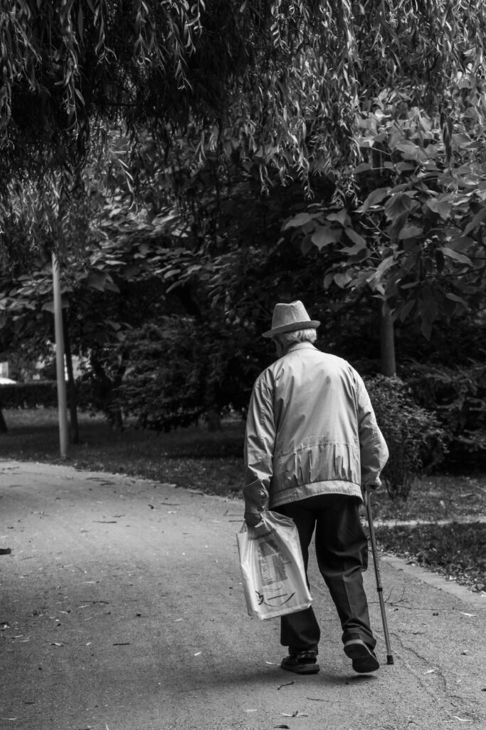 old man walking on street