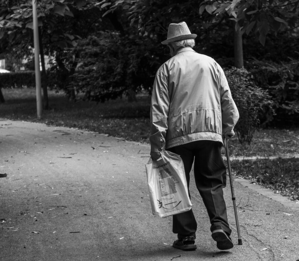 old man walking on street